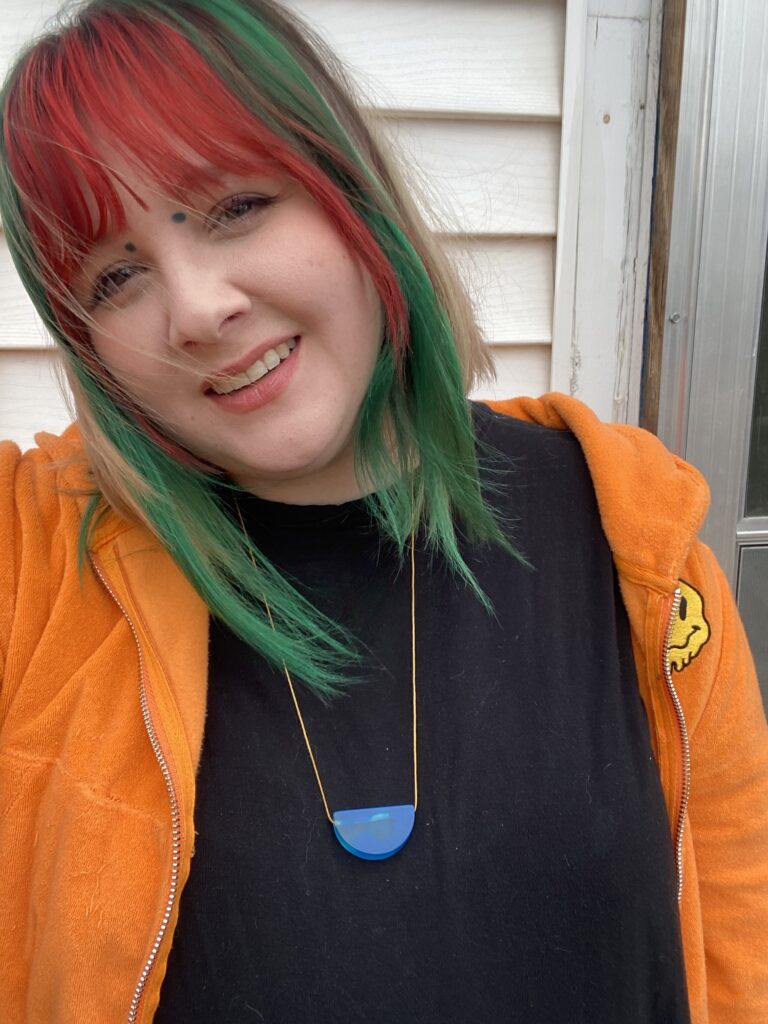 a picture of a person with feminine features and brightly colored hair.